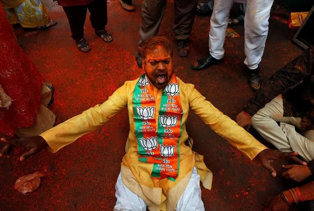 A supporter of the Bharatiya Janata Party (BJP) celebrates after learning of the initial poll results outside the party headquarters in Kolkata, India, March 11, 2017. (Photo by Rupak De Chowdhuri/Reuters)