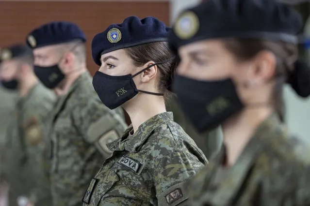 Kosovo Security Force (KSF) members wearing protective face masks line up during a peacekeeping mission deployment ceremony held at the army barracks in Pristina, Tuesday, March 9, 2021. Kosovo is sending a military platoon to Kuwait, its first ever involvement in an international peacekeeping mission. A ceremony was held Tuesday at the army barracks in the capital, Pristina, with the presence of top country leaders and western military attaches. Kosovo is sending the military unit following a request from the U.S. Central Command. (Photo by Visar Kryeziu/AP Photo)