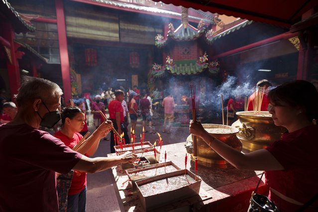 Malaysian ethnic Chinese pray on the first day of Lunar New Year's holidays at a temple in Kuala Lumpur, Malaysia Saturday, February 10, 2024. The Chinese Lunar New Year falls on Feb. 10 this year, marking the start of the Year of the Dragon, according to the Chinese zodiac. (Photo by Vincent Thian/AP Photo)