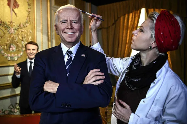 A make-up artist applies the finishing touches to the wax statue of US President Joe Biden as it is unveiled at the Musee Grevin wax museum in Paris on May 18, 2021. The museum is expected to reopen on May 19, 2021 after months of closure due to the coronavirus pandemic. (Photo by Christophe Archambault/AFP Photo)