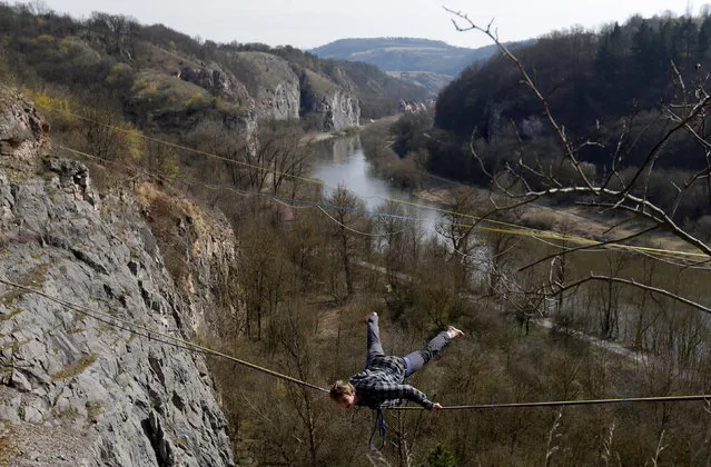 A participant balances on a line during the highline event near the town of Beroun, Czech Republic on March 25, 2017. (Photo by David W. Cerny/Reuters)
