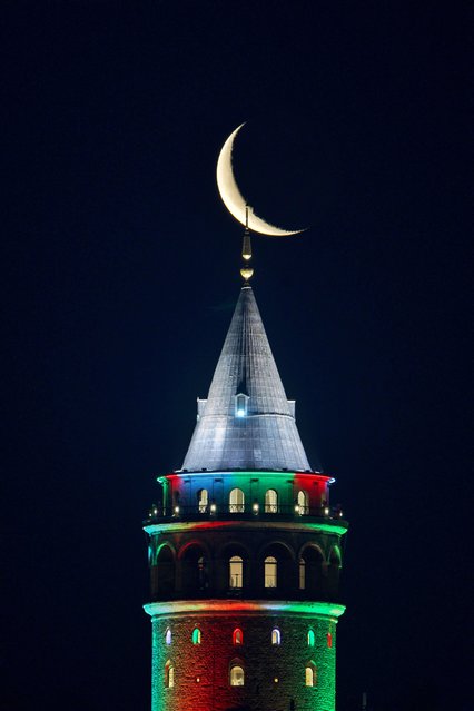 Crescent Moon rises behind Galata Tower in Istanbul, Turkiye on June 03, 2024. (Photo by Nurettin Boydak/Anadolu via Getty Images)