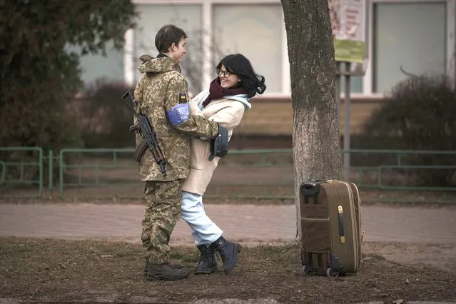 Bogdana, 17, laughs with her boyfriend, Ivan, 19, in Brovary, Ukraine, Sunday, March 20, 2022. Russian forces pushed deeper into Ukraine's besieged and battered port city of Mariupol on Saturday, where heavy fighting shut down a major steel plant and local authorities pleaded for more Western help. (Photo by Vadim Ghirda/AP Photo)