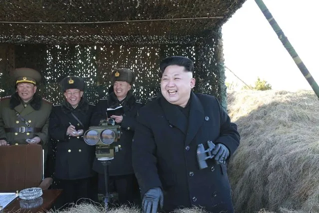 North Korean leader Kim Jong Un (R) laughs as he watches a drill by the Korean People's Army (KPA) for hitting enemy naval target at undisclosed location in this undated photo released by North Korea's Korean Central News Agency (KCNA) in Pyongyang January 31, 2015. (Photo by Reuters/KCNA)