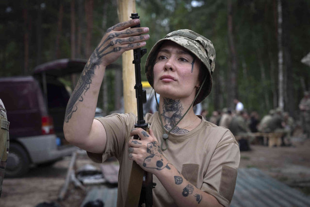 A volunteer of the woman mobile air defence group Bucha Witches practices combat training in Bucha region close to capital Kyiv, Ukraine, Saturday, August 3, 2024. The Bucha Witches group operates in Bucha region to shoot down Russian drones approaching Kyiv. (Photo by Efrem Lukatsky/AP Photo)