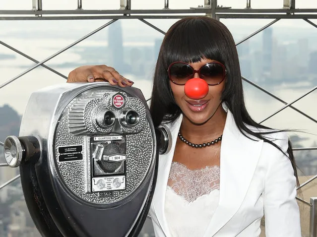 In this May 24, 2016 file photo, model Naomi Campbell poses on the observatory of the Empire State Building in honor of Red Nose Day in New York. With music by Elton John and Blake Shelton, comedy from Tracy Morgan and appearances by more than 60 other celebrities, the live “Red Nose Day Special” on NBC on Thursday, May 26 promises to be as starry a Hollywood awards show, only the winners are children's charities around the world. (Photo by Evan Agostini/Invision/AP Photo)
