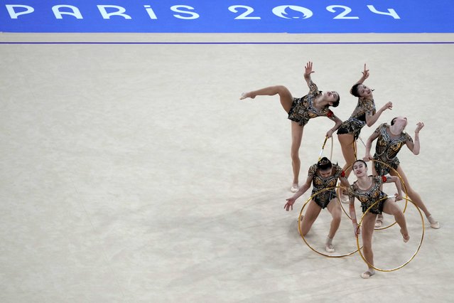 The team from China perform their hoop exercise in the rhythmic gymnastics group all-round qualification round at La Chapelle Arena at the 2024 Summer Olympic, Friday, August 9, 2024, in Paris, France. (Photo by Charlie Riedel/AP Photo)