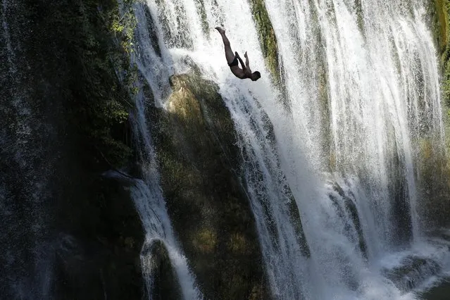 A competitor dives during the international waterfall jumping competition in the old town of Jajce, 250 kms west of Sarajevo, Bosnia, on Saturday, August 1, 2015. A total of 25 competitors took part in the jump at 20 meters high. (Photo by Amel Emric/AP Photo)