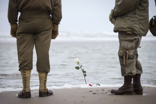 World War II reenactors watch the Atlantic Ocean from Omaha Beach in Saint-Laurent-sur-Mer, Normandy, France, Tuesday, June 6, 2023. The D-Day invasion that helped change the course of World War II was unprecedented in scale and audacity. Nearly 160,000 Allied troops landed on the shores of Normandy at dawn on June 6, 1944. (Photo by Thomas Padilla/AP Photo)