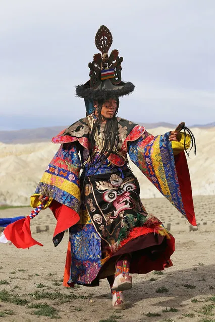 The tsowo, or lead monk during the Tenchi ceremonies, performs ceremonial dances outside of the city gates during the Tenchi Festival on May 27, 2014 in Lo Manthang, Nepal. The Tenchi Festival takes place annually in Lo Manthang, the capital of Upper Mustang and the former Tibetan Kingdom of Lo. Each spring, monks perform ceremonies, rites, and dances during the Tenchi Festival to dispel evils and demons from the former kingdom. (Photo by Taylor Weidman/Getty Images)