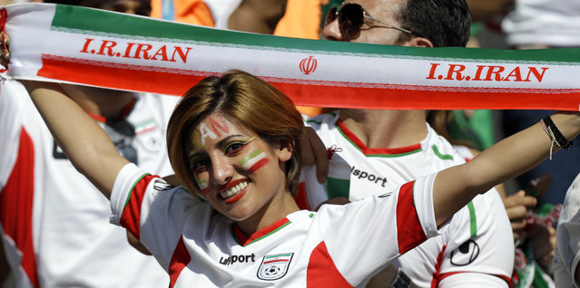 An Iranian supporter holds up a team banner before the group F World Cup soccer match between Argentina and Iran at the Mineirao Stadium in Belo Horizonte, Brazil, Saturday, June 21, 2014. (Photo by Fernando Vergara/AP Photo)