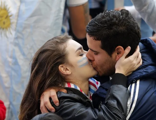Argentina fans kiss as they wait for the team's World Cup semi-final soccer match against the Netherlands, at a public square viewing area in Buenos Aires July 9, 2014. (Photo by Enrique Marcarian/Reuters)