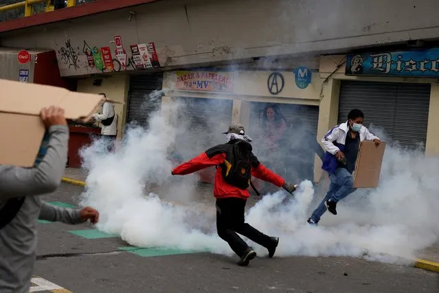 A protester holds a tear gas canister during a confrontation with security personnel after Ecuador's armed forces warned they would not allow ongoing protests against President Guillermo Lasso's economic policies to damage the country's democracy, in Quito, Ecuador on June 21, 2022. (Photo by Santiago Arcos/Reuters)