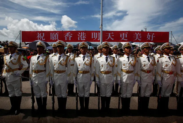 People's Liberation Army naval soldiers stand in front of a banner which reads “Hope Hong Kong has an even better tomorrow” at a naval base, celebrating the 19th anniversary of Hong Kong's handover to Chinese sovereignty from British rule, in Hong Kong July 1, 2016. (Photo by Bobby Yip/Reuters)