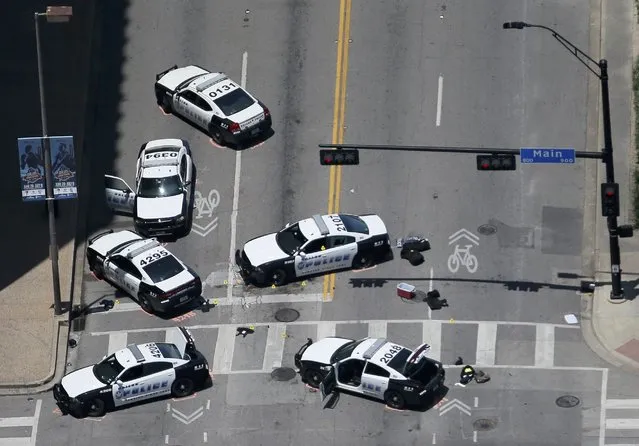 Police cars remain parked with the pavement marked by spray paint, in an aerial view of the crime scene of a shooting attack in downtown Dallas, Texas, U.S. July 8, 2016. (Photo by Brandon Wade/Reuters)