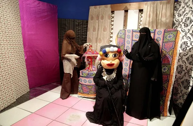 Heba Seraj, Shaimaa Hamid and Shaimaa Abdelhamid prepare to film a segment of a Ramadan program at the Maria Channel's studio in Cairo on July 22, 2012. The first Egyptian satellite channel operated by women wearing the niqab, or face veil, launched on the first day of the holy month of Ramadan. The station manager says he hopes the full face-veiled women will set an example for others by showing a “new kind of woman” as a role model. (Photo by Maya Alleruzzo/Associated Press)