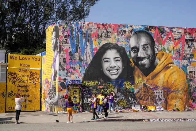 Fans gather around a mural of late NBA great Kobe Bryant and his daughter Gianna Bryant during a public memorial for them and seven others killed in a helicopter crash, at the Staples Center in Los Angeles, California, U.S., February 24, 2020. (Photo by Kyle Grillot/Reuters)