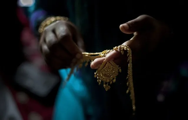 Gold wedding jewelry is laid out for 15 year old Nasoin Akhter on the day of her wedding to a 32 year old man, August 20, 2015 in Manikganj, Bangladesh. In June of this year, Human Rights Watch released a damning report about child marriage in Bangladesh. The country has one of the highest rates of child marriage in the world, with 29% of girls marrying before the age of 15, and 65% of girls marrying before they turn 18. (Photo by Allison Joyce/Getty Images)