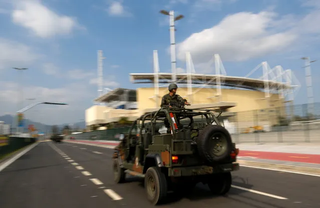 Brazilian Army soldiers patrol in front of the Olympic park ahead of the 2016 Rio Olympics in Rio de Janeiro, Brazil, July 19, 2016. (Photo by Bruno Kelly/Reuters)