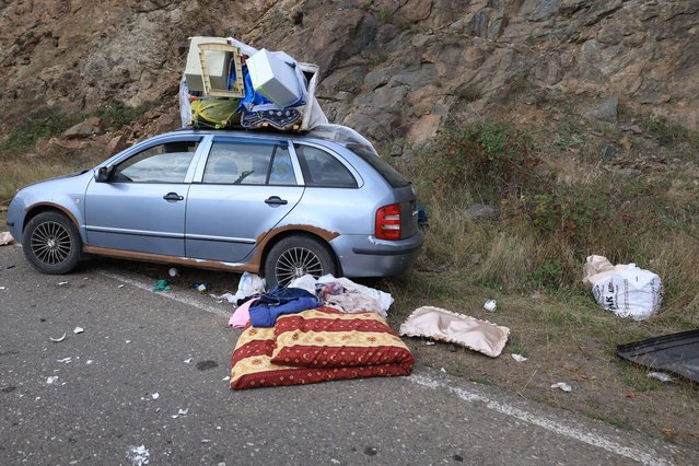 An abandoned car left by fleeing Armenians is seen on the side of a road leading to the Lachin corridor, during an Azeri government organized media trip, in Azerbaijan's controlled region of Nagorno-Karabakh, on October 3, 2023. (Photo by Emmanuel Dunand/AFP Photo)