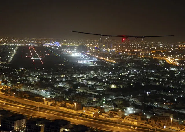 The Solar Impulse 2 plane approaches to land at Al Bateen Executive Airport in Abu Dhabi, United Arab Emirates, on Tuesday, July 26, 2016. The world’s first ever round-the-world flight to be powered solely by the sun’s energy made history with its landing in the Emirati capital, where it first took off on an epic 22,000-mile (35,000 kilometer) journey more than a year ago. (Photo by Adam Schreck/AP Photo)