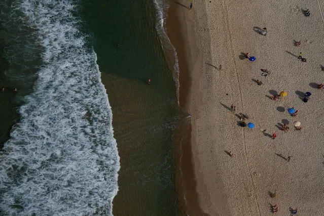 An aerial view shows people on Copacabana beach in Rio de Janeiro, Brazil, July 16, 2016. (Photo by Ricardo Moraes/Reuters)