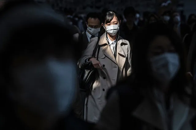 Commuters wearing face masks walk through Shinagawa train station on April 8, 2020 in Tokyo, Japan. Japans Prime Minister, Shinzo Abe, yesterday declared a state of emergency that will cover 7 of Japans 47 prefectures, including Tokyo and Osaka, as the Covid-19 coronavirus outbreak continues to spread in the country. The move will allow affected prefectures to take measures including expropriating private land and buildings and requisitioning medical supplies and food from companies that refuse to sell them. Tokyo recorded 80 new infections on Tuesday bringing the total in the capital to 1,196 with 85 deaths nationwide. (Photo by Carl Court/Getty Images)