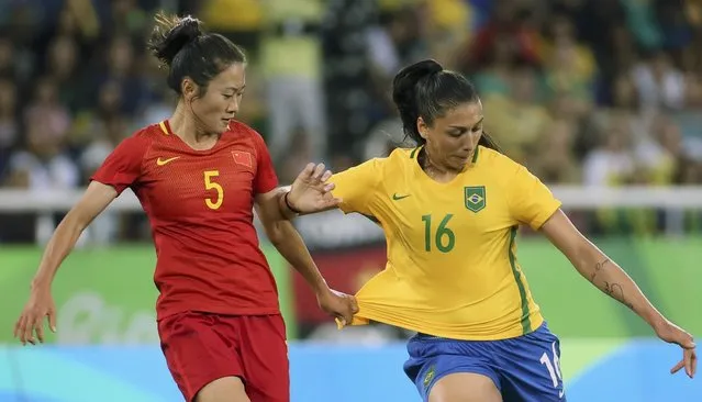 Soccer, Preliminary, Women's First Round, Group E Brazil vs China, Olympic Stadium in Rio de Janeiro, Brazil on August 3, 2016. Wu Haiyan (CHN) of People's Republic of China and Beatriz (BRA) of Brazil in action. (Photo by Gonzalo Fuentes/Reuters)