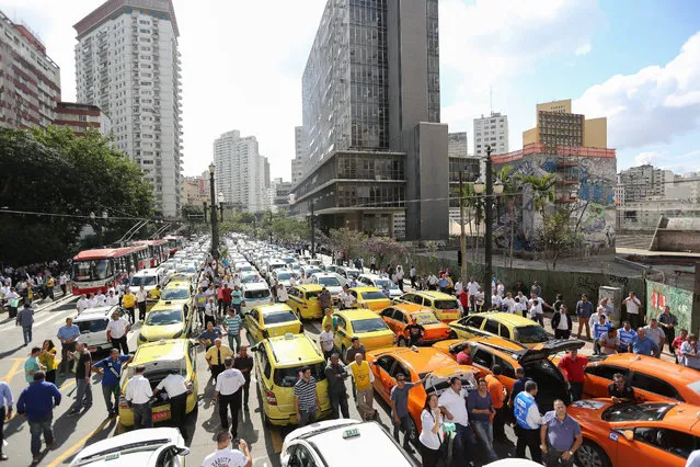 Thousands of taxi drivers block the main roads of downtown Sao Paulo, Brazil, 09 September 2015. The demonstrators were protesting against ride-sharing service “Uber”. (Photo by Leo Barrilari/EPA)