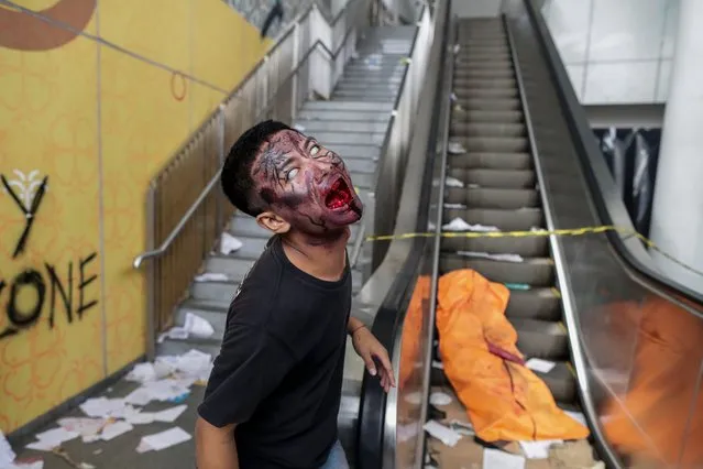 An actor performs as a zombie during the “Train to Apocalypse” event at a Light Rail Transit (LRT) train station in Jakarta, Indonesia, 09 September 2022. The Indonesian capital's LRT operator modified train cars and stations into zombie apocalypse settings to promote the use of public transportations. (Photo by Mast Irham/EPA/EFE/Rex Features/Shutterstock)