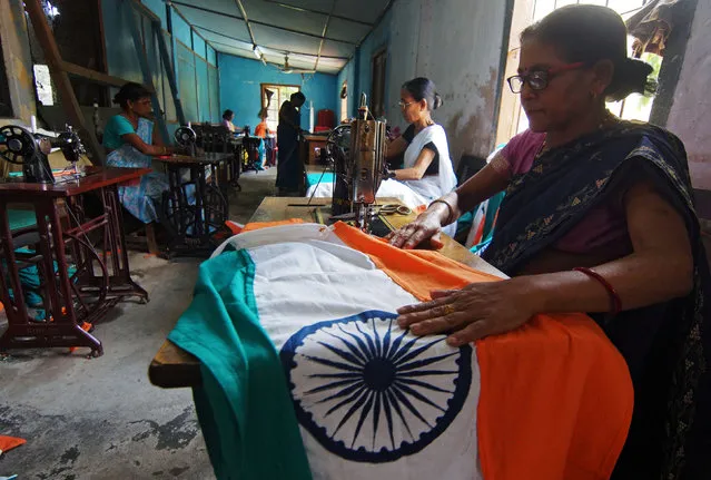 Workers stitch Indian national flags at a workshop ahead of Independence Day celebrations in Guwahati, India, August 11, 2016. (Photo by Reuters/Stringer)