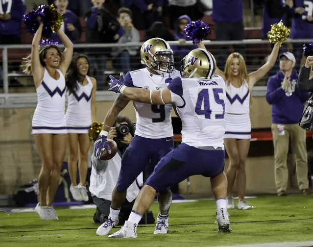 Washington running back Myles Gaskin (9) celebrates his rushing touchdown with teammate Jusstis Warren, right, during the first half of an NCAA college football game Friday, November 10, 2017, in Stanford, Calif. (Photo by Marcio Jose Sanchez/AP Photo)