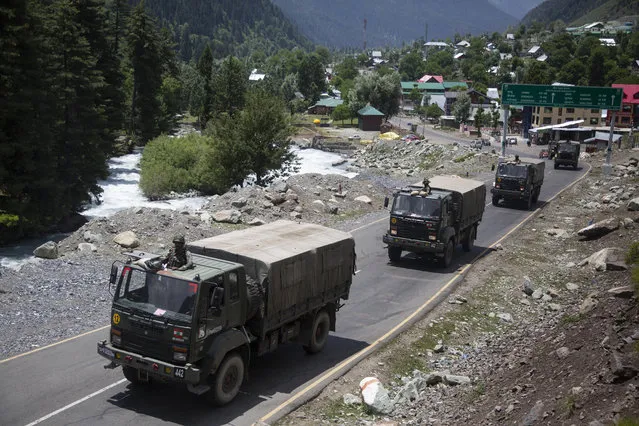 An Indian army convoy moves on the Srinagar- Ladakh highway at Gagangeer, north-east of Srinagar, India, Wednesday, June 17, 2020. Indian security forces said neither side fired any shots in the clash in the Ladakh region late Monday that was the first deadly confrontation on the disputed border between India and China since 1975. China said Wednesday that it is seeking a peaceful resolution to its Himalayan border dispute with India following the death of 20 Indian soldiers in the most violent confrontation in decades. (Photo by Mukhtar Khan/AP Photo)