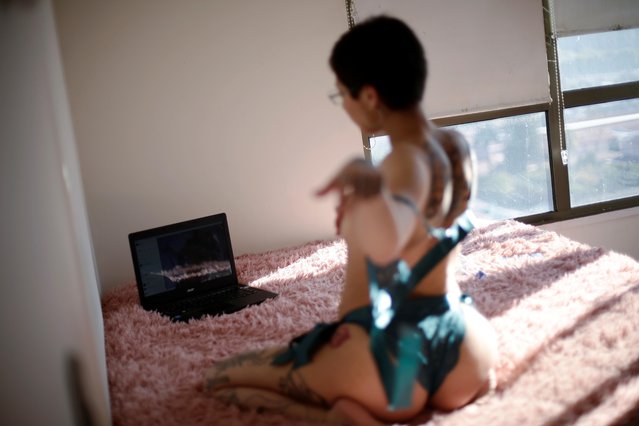 Camila Hormazabal, a 24-year-old sеx worker, uses a laptop to connect to the web and keep an online erotic meeting with a virtual customer in Concepcion, Chile on April 7, 2020. Hormazabal reinvented herself offering sexual services online after the nightclub where she had worked was closed due to the outbreak of the coronavirus disease (COVID-19). (Photo by Juan Gonzalez/Reuters)