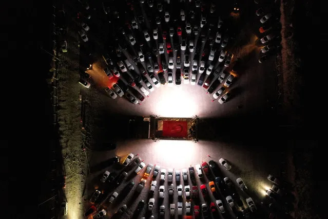 An aerial view of people watching a movie from their cars at an open air cinema event, held within the novel coronavirus (COVID-19) measures, in Nevsehir, Turkey on May 30, 2020. (Photo by Behcet Alkan/Anadolu Agency via Getty Images)