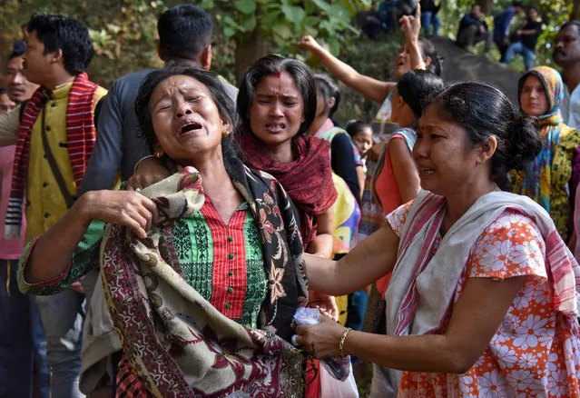 Women cry after police demolished their huts which forest officials claimed were illegally built at the Amchang Wildlife Sanctuary in Guwahati, November 27, 2017. (Photo by Anuwar Hazarika/Reuters)