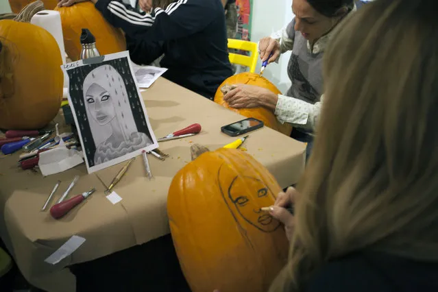 Artist Tara McPherson works on drawing on a stencil on a pumpkin at Cotton Candy Machine in Brooklyn, N.Y. on October 18, 2014. (Photo by Siemond Chan/Yahoo Finance)