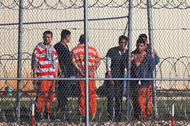 Detainees stand behind a fence at the Bluebonnet Detention Facility, where Venezuelans at the center of a Supreme Court ruling on deportation are held, in Anson, Texas on April 22, 2025. (Photo by Daniel Cole/Reuters)