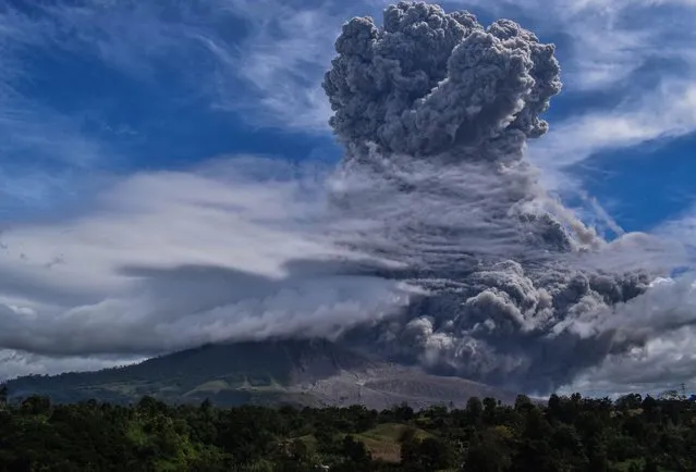 Mount Sinabung spews thick ash and smoke into the sky in Karo, North Sumatra on August 10, 2020. (Photo by Anto Sembiring/AFP Photo)