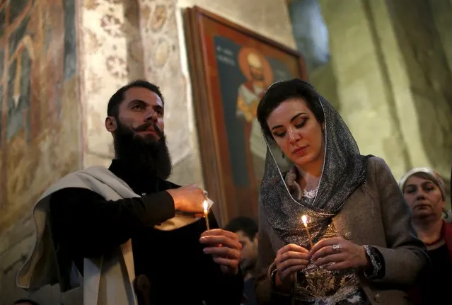 People attend a religious service at the Svetitskhoveli Cathedral in Georgia's ancient capital Mtskheta October 14, 2015. The Georgian Orthodox Church on Wednesday celebrated the day of the "Heaton of the Lord and the Holy Exuding Miraculous Pillar", also known as the Day of the Svetitskhoveli Cathedral. (Photo by David Mdzinarishvili/Reuters)