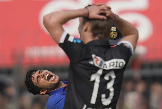 India's Shubhman Gill, left, celebrates scoring a century as New Zealand's Blair Tickner watches during the third one-day international cricket match between India and New Zealand in Indore, India, Tuesday, January 24, 2023. (Photo by Rajanish Kakade/AP Photo)