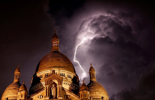 Lightning illuminates the sky above the Sacre Coeur basilica during the Paris 2024 Olympic Games, in Paris, France on August 1, 2024. (Photo by Stefan Wermuth/Reuters)