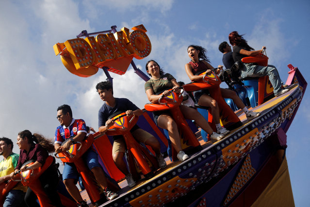Visitors enjoy a ride in a fair during the festivities of El Divino Salvador del Mundo (The Divine Savior of the World), patron saint of the capital city of San Salvador, in San Salvador, El Salvador on August 7, 2025. (Photo by Jose Cabezas/Reuters)