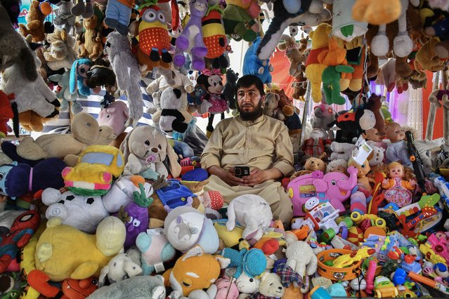 An Afghan vendor selling toys waits for the customers at a market in Mazar-i-Sharif on June 16, 2025. (Photo by Atif Aryan/AFP Photo)