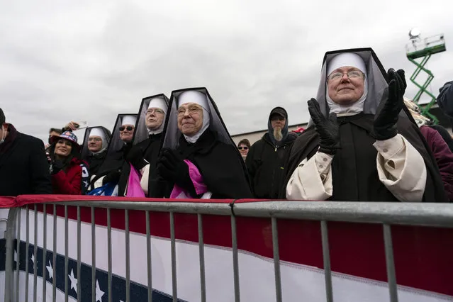 Nuns with the Dominican Sisters of Hartland, Mich., applaud as President Donald Trump speaks at a campaign rally at Oakland County International Airport, Friday, October 30, 2020, at Waterford Township, Mich. (Photo by Alex Brandon/AP Photo)