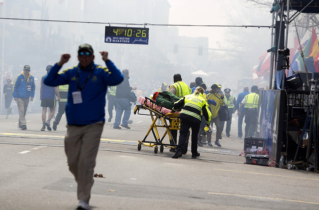 First responders rush to where two explosions occurred along the final stretch of the Boston Marathon on Boylston Street in Boston, Massachusetts, U.S., on Monday, April 15, 2013. (Photo by Kelvin Ma/Bloomberg)