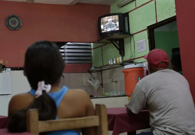 People watch television footage showing Cuba's president Raul Castro speaking during a state television broadcast in a private restaurant in Havana December 17, 2014. (Photo by Enrique De La Osa/Reuters)