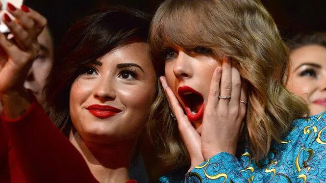 Recording artists Demi Lovato (L) and Taylor Swift take a selfie at the 2014 MTV Video Music Awards at The Forum on August 24, 2014 in Inglewood, California. (Photo by Jeff Kravitz/MTV1415/FilmMagic)