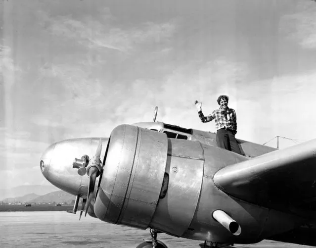 American aviatrix Amelia Earhart waves from the Electra before taking off from Los Angeles, Ca., on March 10, 1937. Earhart is flying to Oakland, Ca., where she and her crew will begin their round-the-world flight to Howland Island on March 18. (Photo by AP Photo)