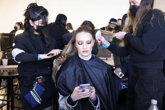 Stylists prepare a model backstage before the Marrisa Wilson show during Fashion Week in New York City, New York, U.S., February 15, 2022. (Photo by Caitlin Ochs/Reuters)